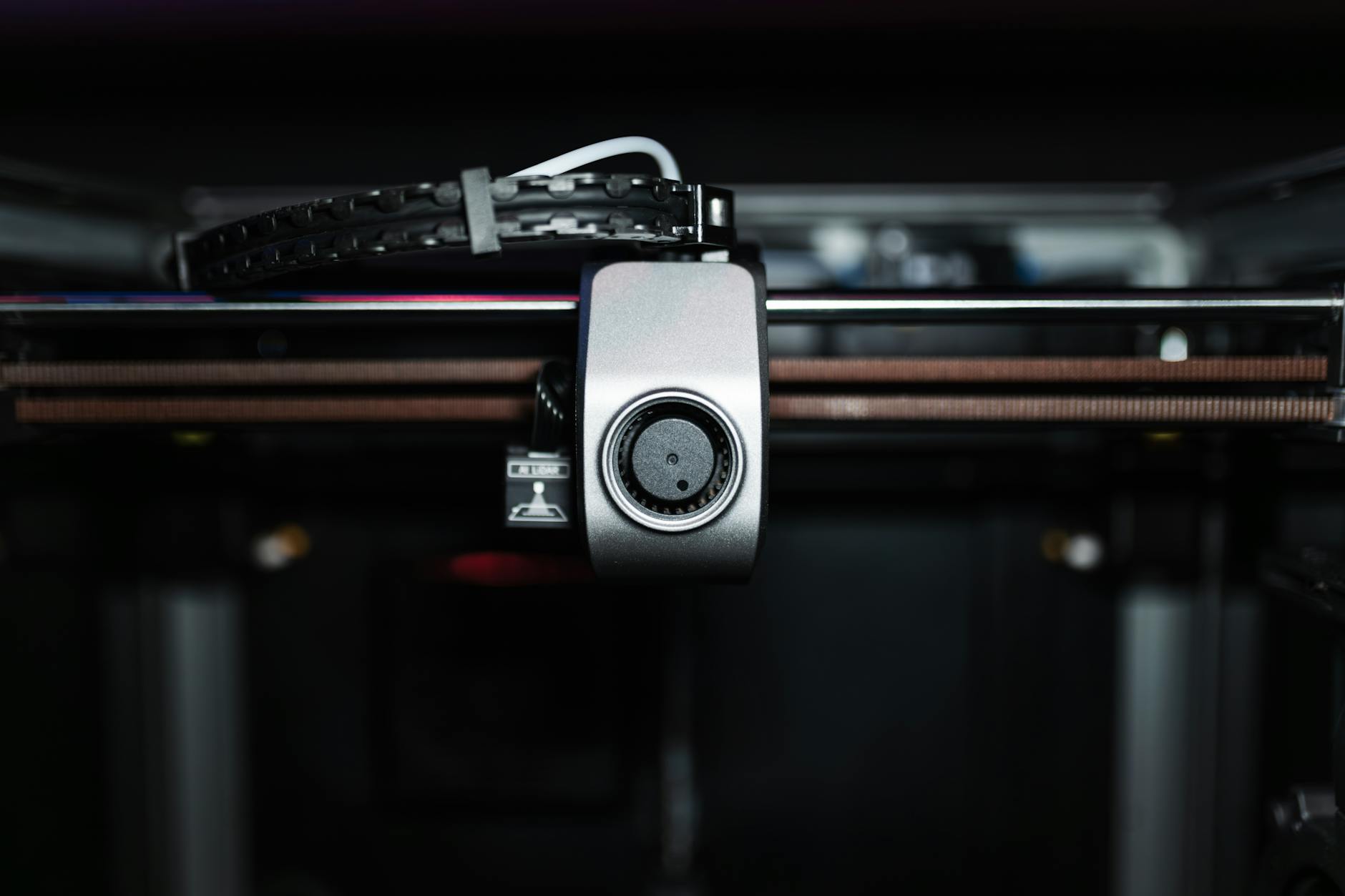 Macro shot of a 3D printer nozzle highlighting technology and precision.