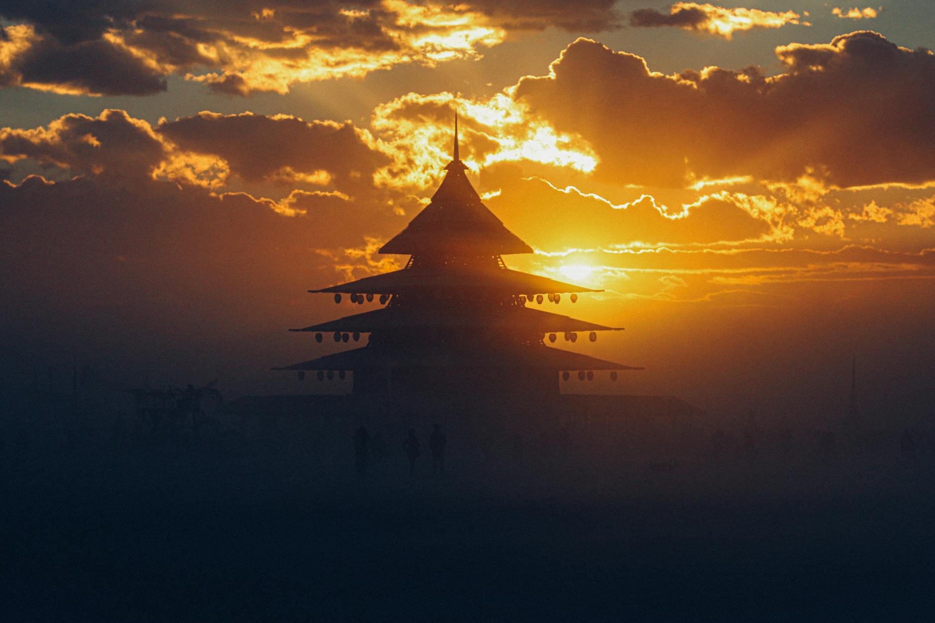 Dramatic silhouette of a pagoda during sunset at Burning Man festival, Nevada.