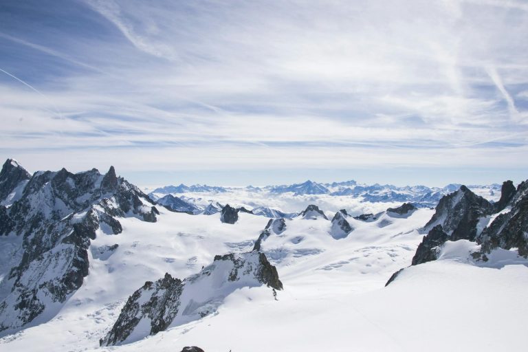 Breathtaking view of Mont Blanc showcasing its icy, rugged peaks under a blue sky