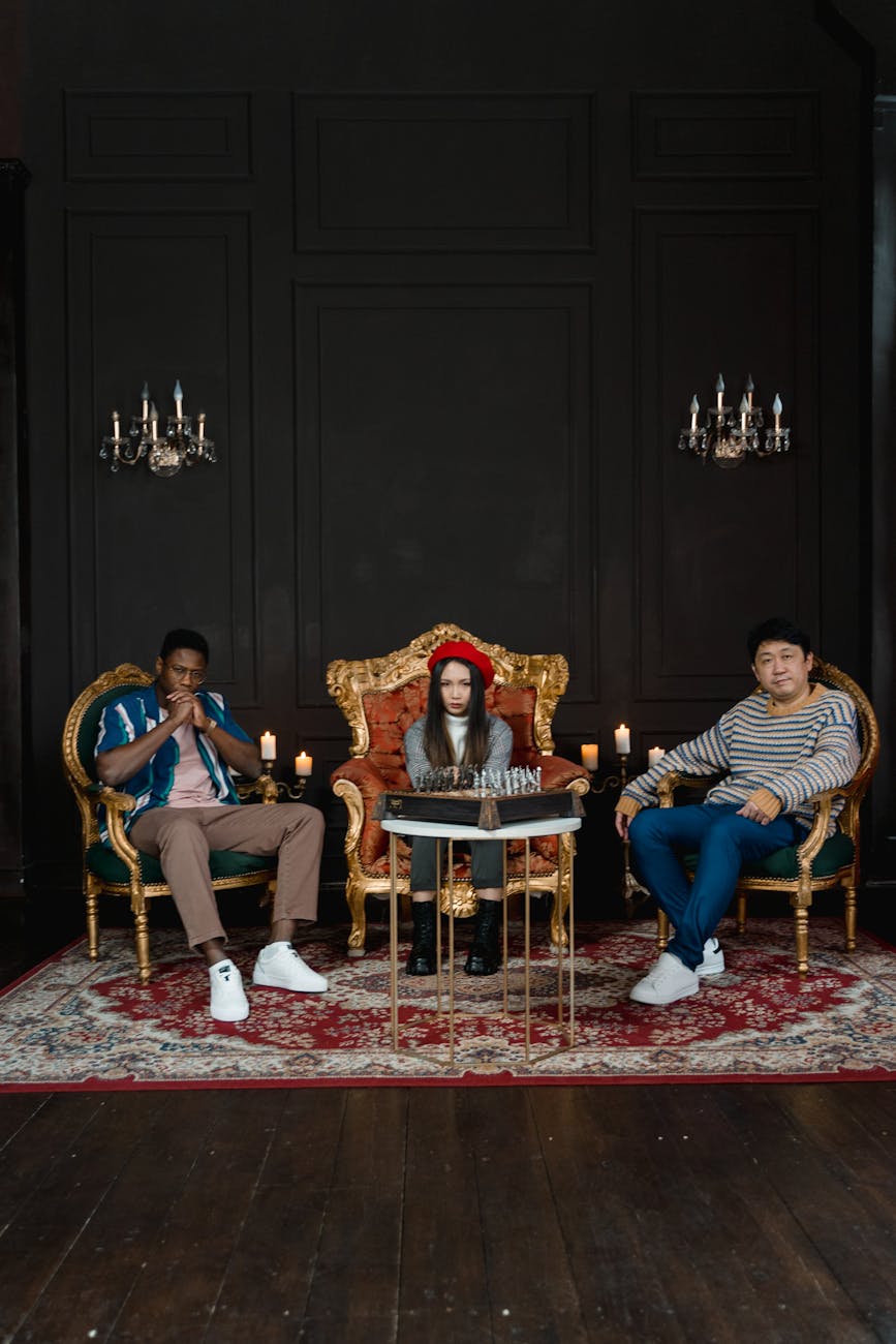 A diverse group of people playing chess in an ornate, elegant room with a luxurious setup.