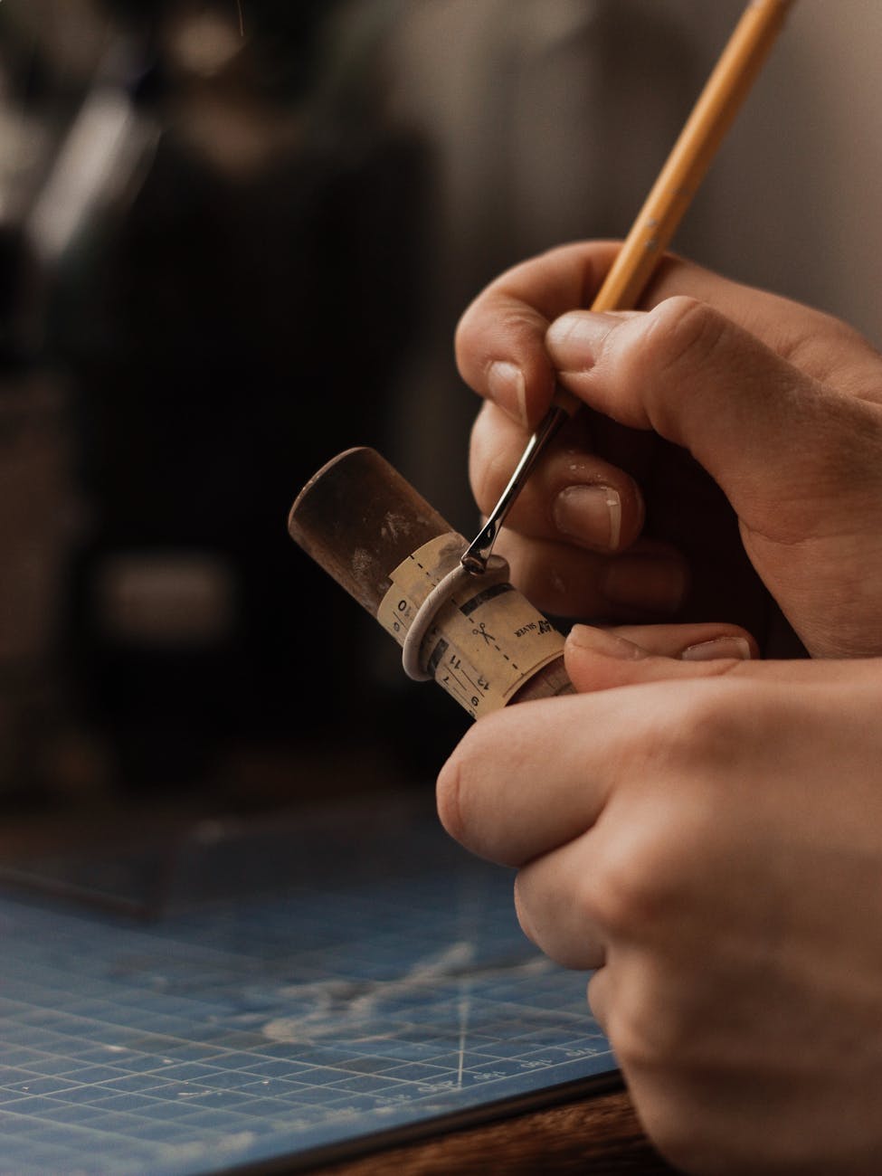 Close-up of hands crafting a ring in a Belarusian workshop, showcasing precision and artistry.