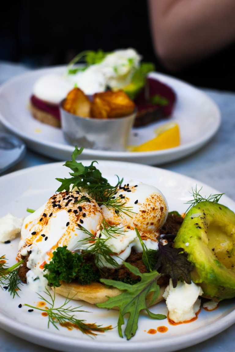 Delicious poached eggs served with avocado and fresh greens, perfect for a healthy gourmet brunch.