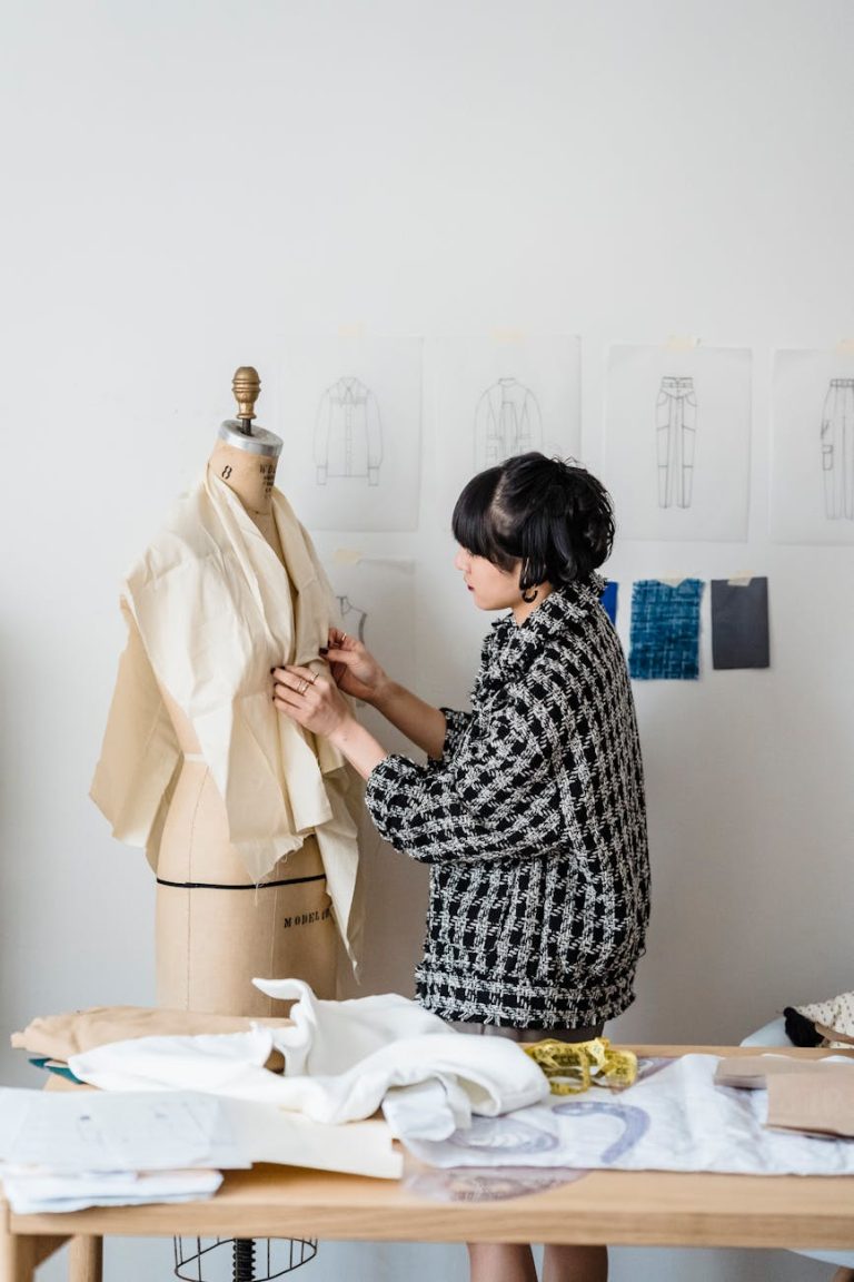 Woman fashion designer working on a dress in a bright studio.