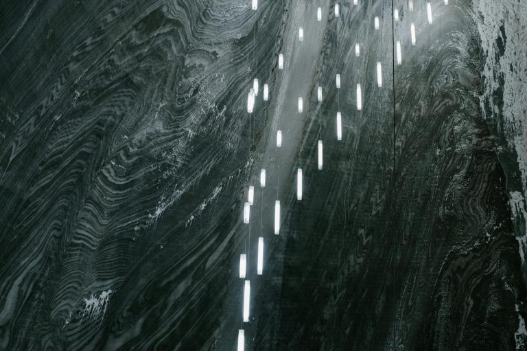 A visually stunning view inside a salt mine in Romania, showcasing illuminated textured walls.