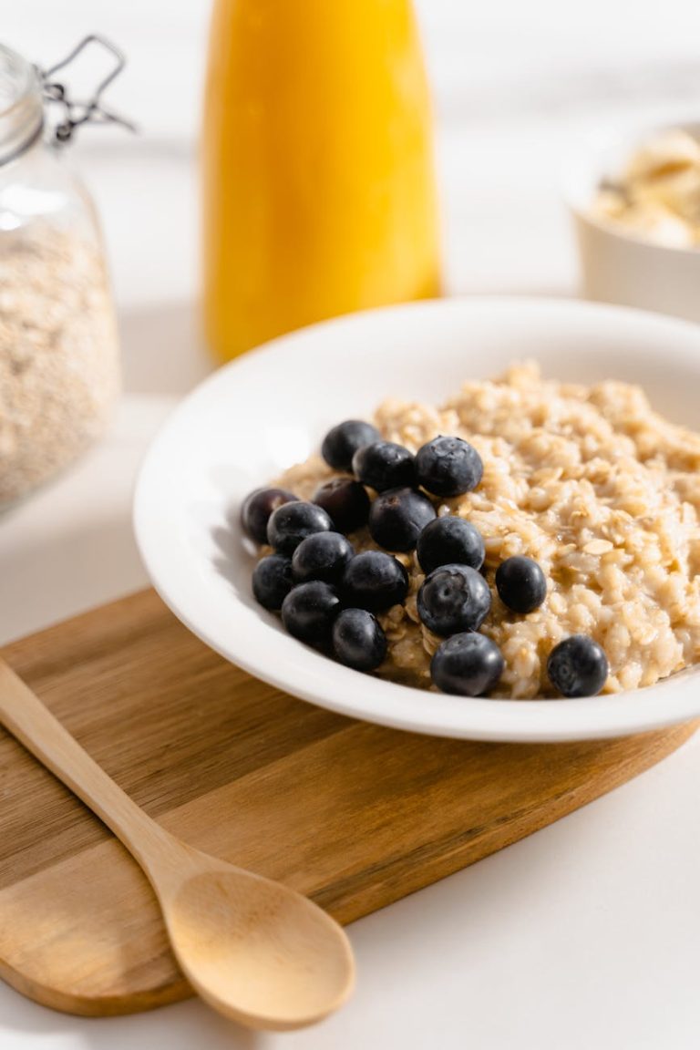 A bowl of creamy oatmeal topped with fresh blueberries, perfect for a nutritious breakfast.