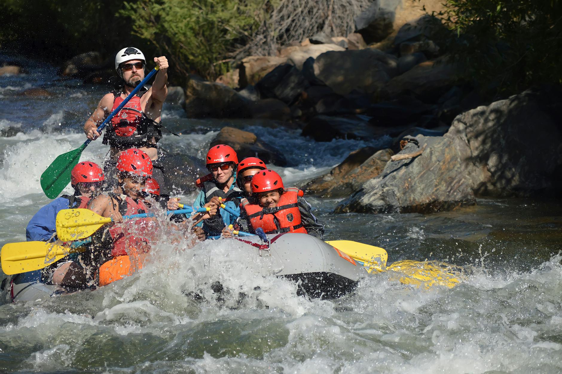 Group enjoying a thrilling whitewater rafting experience on a rapid river.