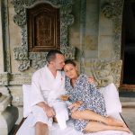 A couple relaxing in a spa setting with ornate decor, enjoying a peaceful time together.