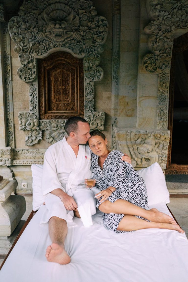 A couple relaxing in a spa setting with ornate decor, enjoying a peaceful time together.