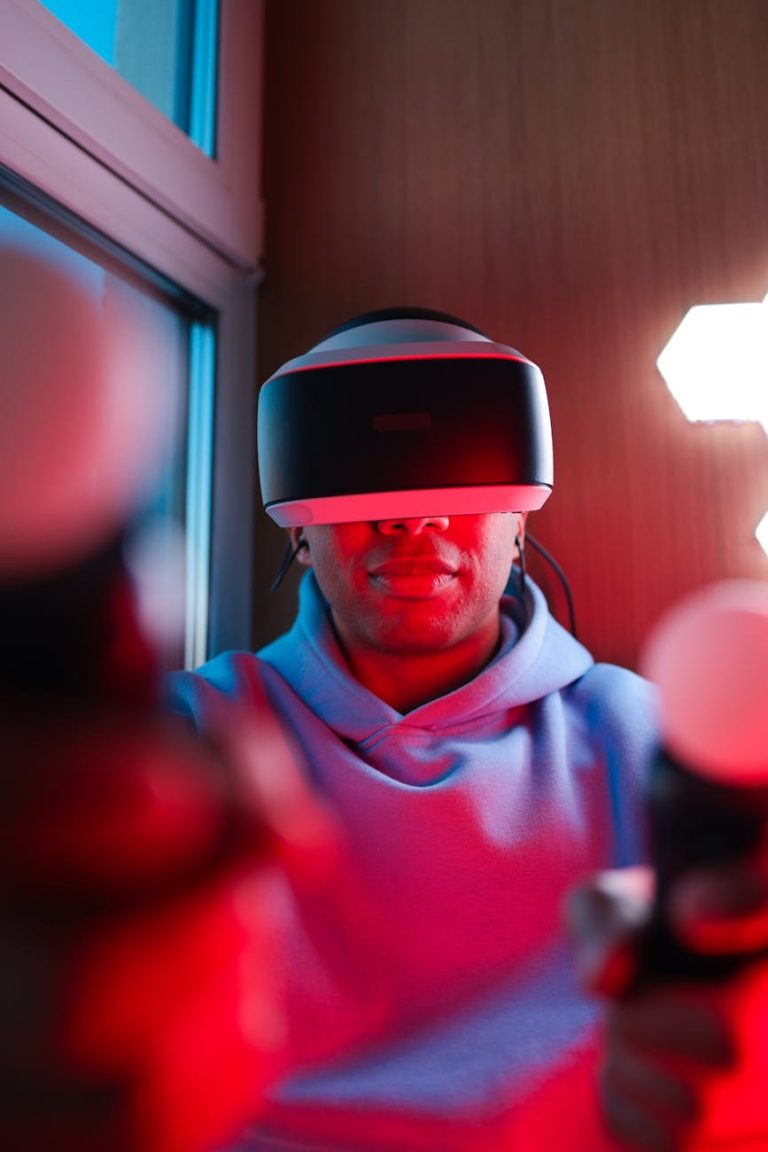 Man wearing VR headset intensely engaged in a virtual simulation indoors.